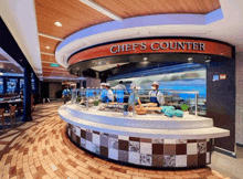 a chef 's counter in a restaurant with chefs working