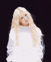 a girl with blonde hair wearing a white jacket that says kd