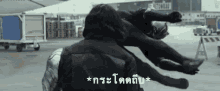 a black panther is flying through the air next to a man in a superhero suit .