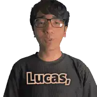 a man wearing glasses and a black shirt with the word lucas on it
