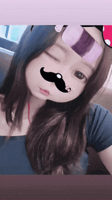 a girl with a fake mustache on her nose