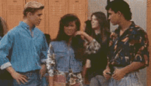 a group of young people are standing in front of lockers .