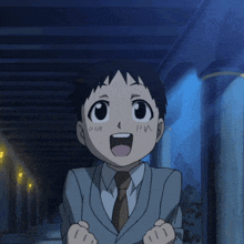 a young boy in a suit and tie is smiling