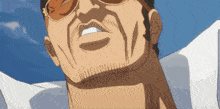 a close up of a man 's face with a beard wearing sunglasses