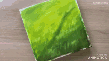 a person is painting a picture of a field of grass with lemon yellow paint