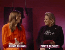 allison williams and tracy e. gilchrist are sitting next to each other in front of a poster