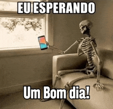 a skeleton is sitting on a couch holding a cell phone and looking out a window .