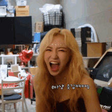 a woman with blonde hair is making a funny face with korean writing on the bottom