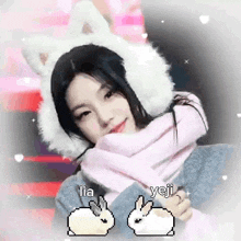 a girl wearing a white hat and a pink scarf is holding a rabbit .