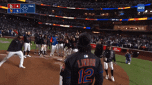 a baseball player with the number 12 on the back of his shirt