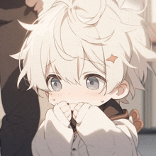 a little boy with white hair and blue eyes has a star on his head