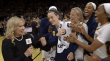 a group of female basketball players including one wearing a jersey that says ' er ' on it