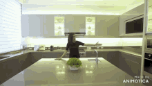 a woman stands in a kitchen with the words made in animotica on the bottom right