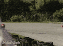 a car is driving down a road with the words motorweek on the bottom right