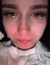 a close up of a woman 's face with a tear coming out of her eyes