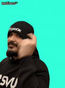 a man with a beard wearing a black beanie and a black hoodie with the word svm on it