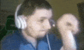 a man wearing headphones and a blue jacket