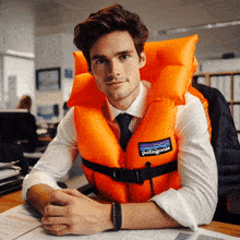 a man wearing an orange patagonia life jacket