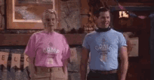 a man and a woman are standing next to each other in a room .