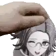 a hand is putting a donut on the head of a girl with glasses .