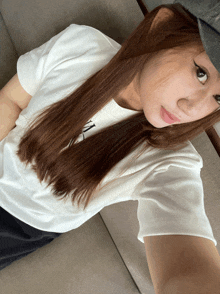a woman wearing a hat and a white t-shirt with the letter n on it