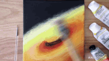 a bottle of acrylic paint sits next to a brush on a canvas