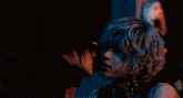 a man and a woman are kissing in the dark in a dark room .
