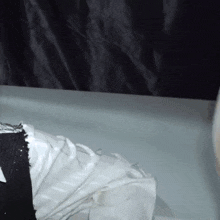 a person is laying in a bathtub with a white cloth on their feet .