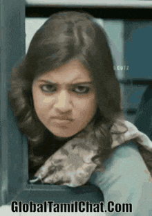 a woman with a scarf around her neck is making a funny face with the website globaltamilchat.com written below her