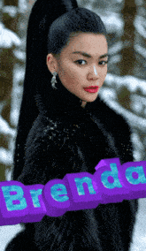 a woman in a black fur coat stands in the snow with the name brenda