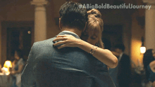 a man and a woman hugging with a big bold beautiful journey written in the corner