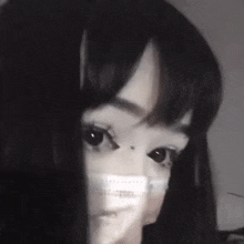 a black and white photo of a woman wearing a mask .