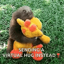 a baby sloth is hugging a stuffed giraffe .