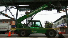 a green sunbelt rentals truck is parked on the street