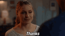 a woman in a white shirt says thanks to a man in a blue shirt