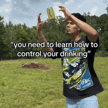 a man wearing a shirt with the number 99 on it throws a can of beer in the air