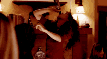 a woman in a red dress is holding a bottle in her mouth