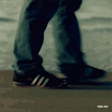 a person 's feet are shown in a blurry photo with the words rbd.gif below them