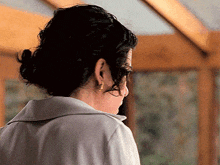 the back of a woman 's head with a bun