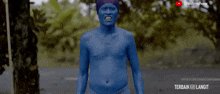 a shirtless man with blue paint on his face is standing in front of a sign that says terbaik hari langit