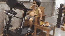 a woman is on a treadmill that says sport on it