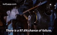 a man is looking at a machine with the words `` there is a 97.6% chance of failure . ''