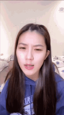a woman wearing a blue hoodie that says ' jal ' on it