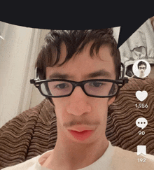 a man wearing glasses and a white shirt has a heart and a speech bubble