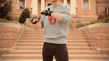 a man wearing a blue sweatshirt with a red u on it