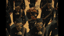 a group of soldiers wearing gas masks and bullet belts