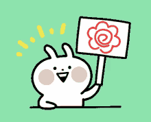 a cartoon bunny is holding up a sign with a red flower on it