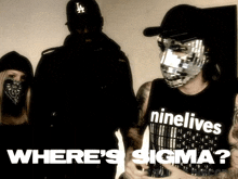 a man wearing a ninelives shirt stands in front of a group of people
