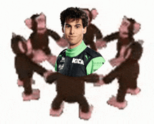 a man with the word kick on his shirt surrounded by monkeys