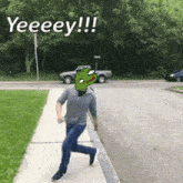 a man is running down a sidewalk with a frog on his face and the words yeeeey !!! written above him